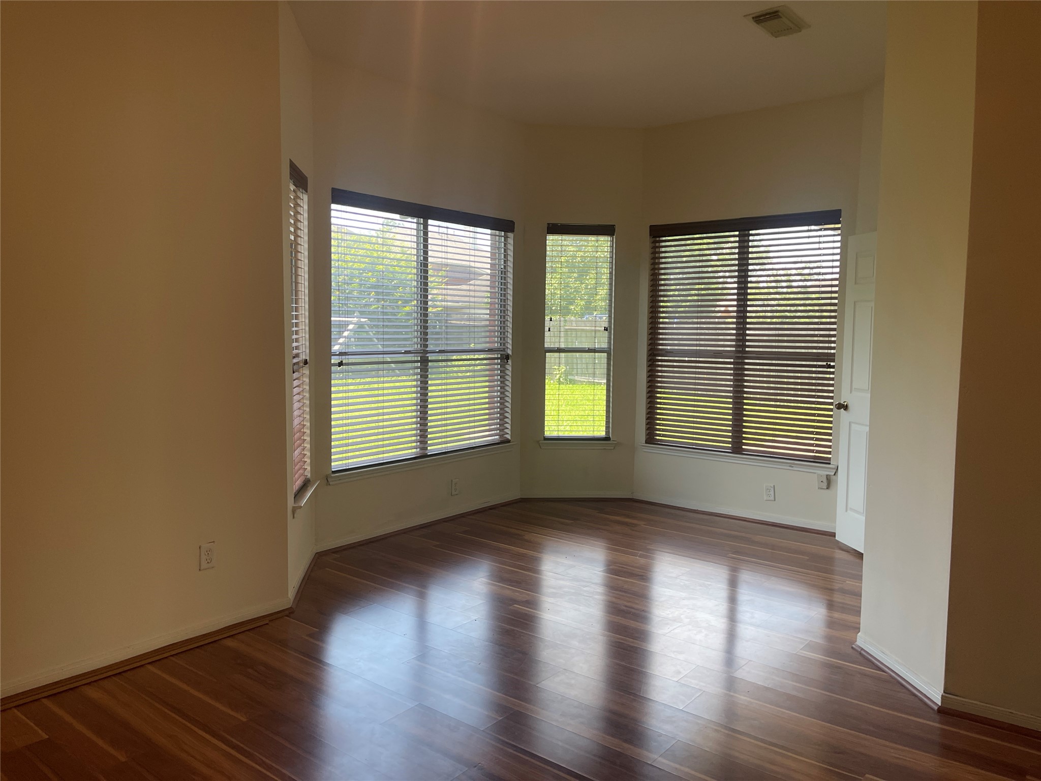13113 Sunset Cliff Court Sugar Land, TX 77478 - Photo 10 of 22 a view of an empty room with wooden floor and a window
