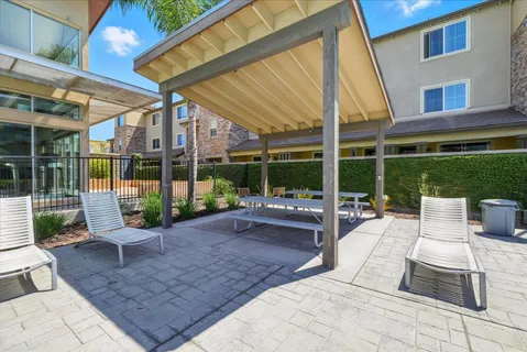 a view of a patio with a dining table and chairs