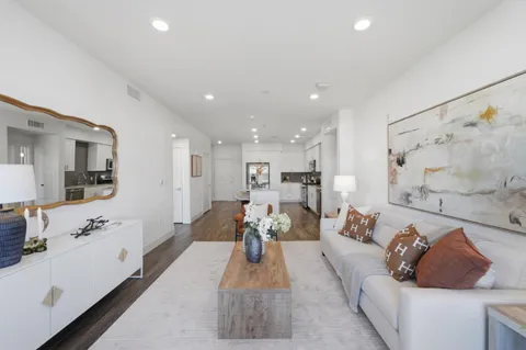 a living room with furniture and white walls