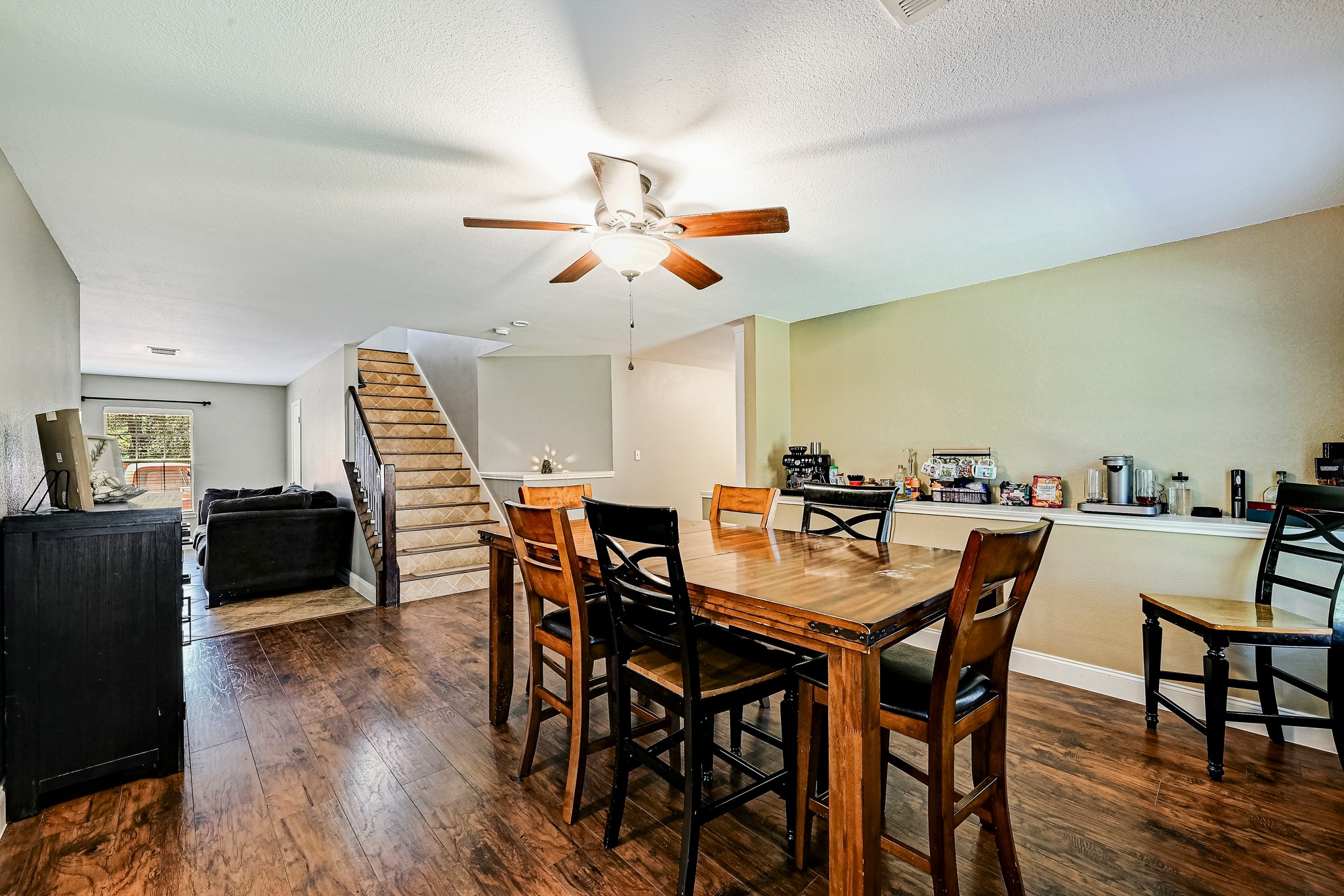 104 North Sumac Lane Georgetown, TX 78633 - Photo 23 of 40 Rich hardwood floors unite the dining and living areas, offering a seamless flow for daily living.