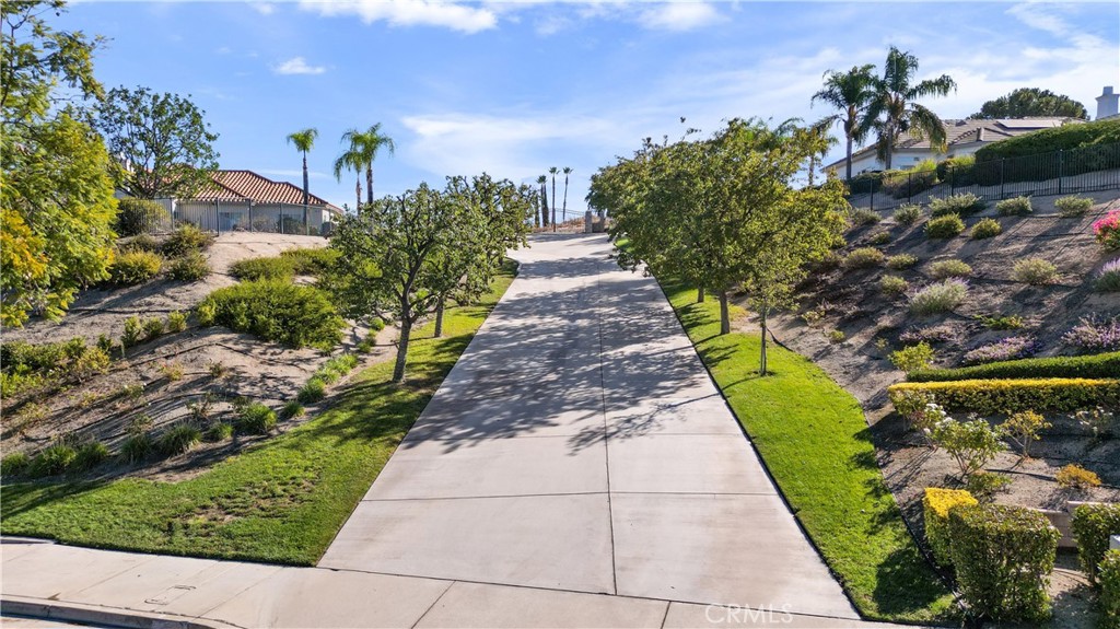 6204 Claridge Drive Riverside, CA 92506 - Photo 2 of 27 Private driveway flanked by mature trees leads to private gate
