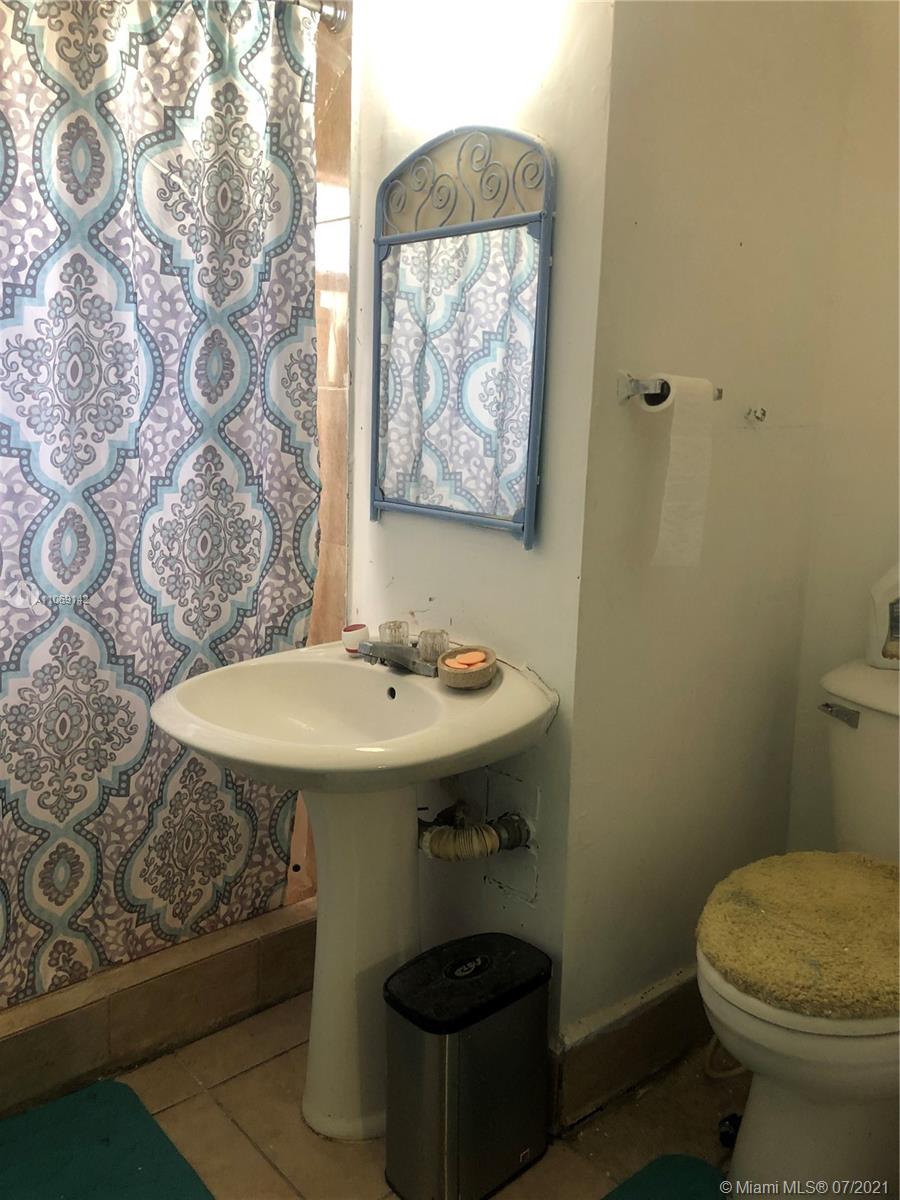 2925 Northwest 96th Street Miami, FL 33147 - Photo 11 of 11 a bathroom with a sink a toilet and mirror