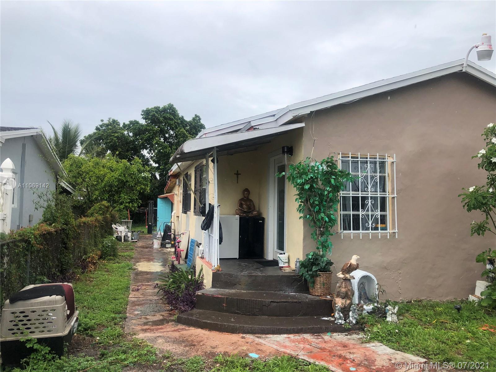 2925 Northwest 96th Street Miami, FL 33147 - Photo 5 of 11 a front view of a house with garden