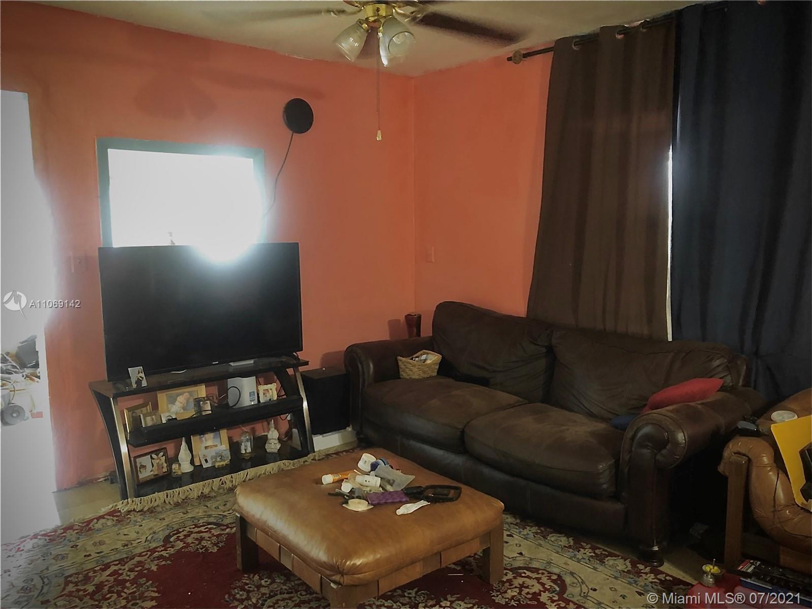 2925 Northwest 96th Street Miami, FL 33147 - Photo 7 of 11 a living room with furniture and a flat screen tv