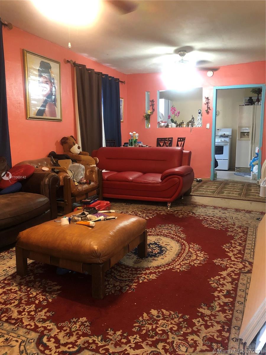 2925 Northwest 96th Street Miami, FL 33147 - Photo 8 of 11 a bedroom with furniture and a mirror