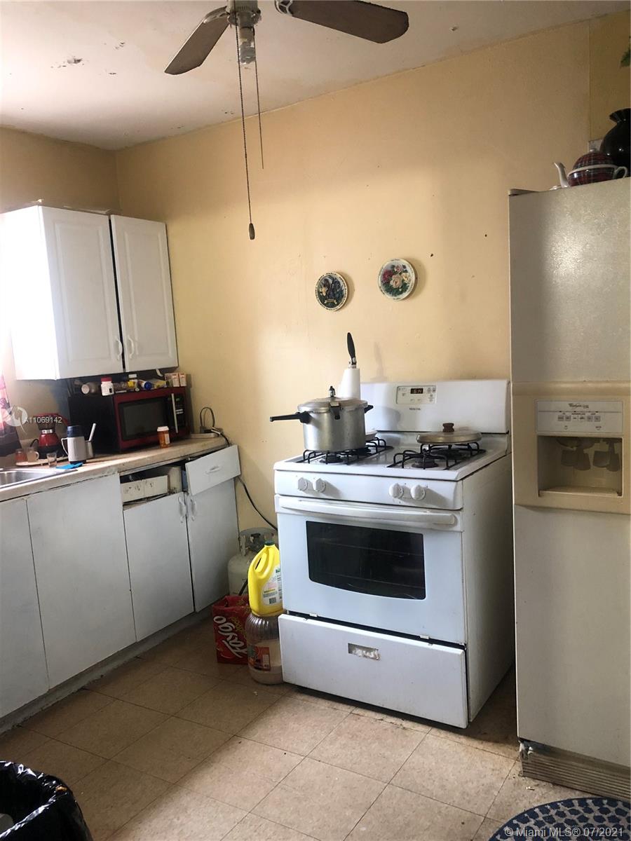 2925 Northwest 96th Street Miami, FL 33147 - Photo 9 of 11 a kitchen with stainless steel appliances kitchen island a stove and a sink