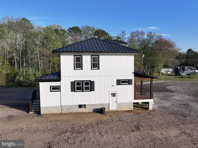 a view of a white house with a yard