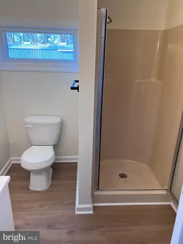 a white toilet sitting next to a bathroom sink