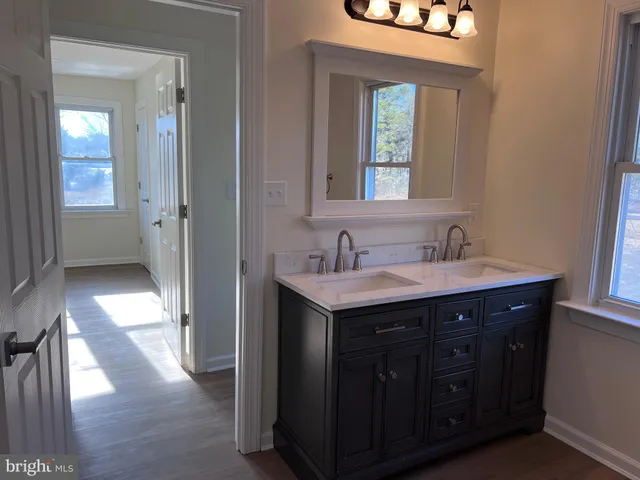 a bathroom with a double vanity sink and a mirror