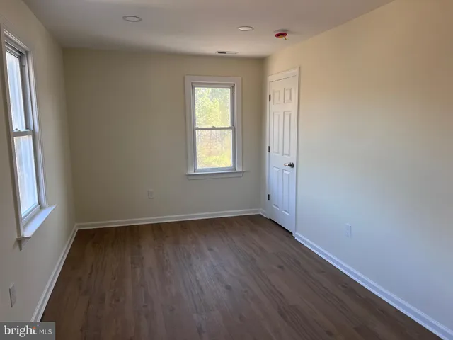 an empty room with wooden floor