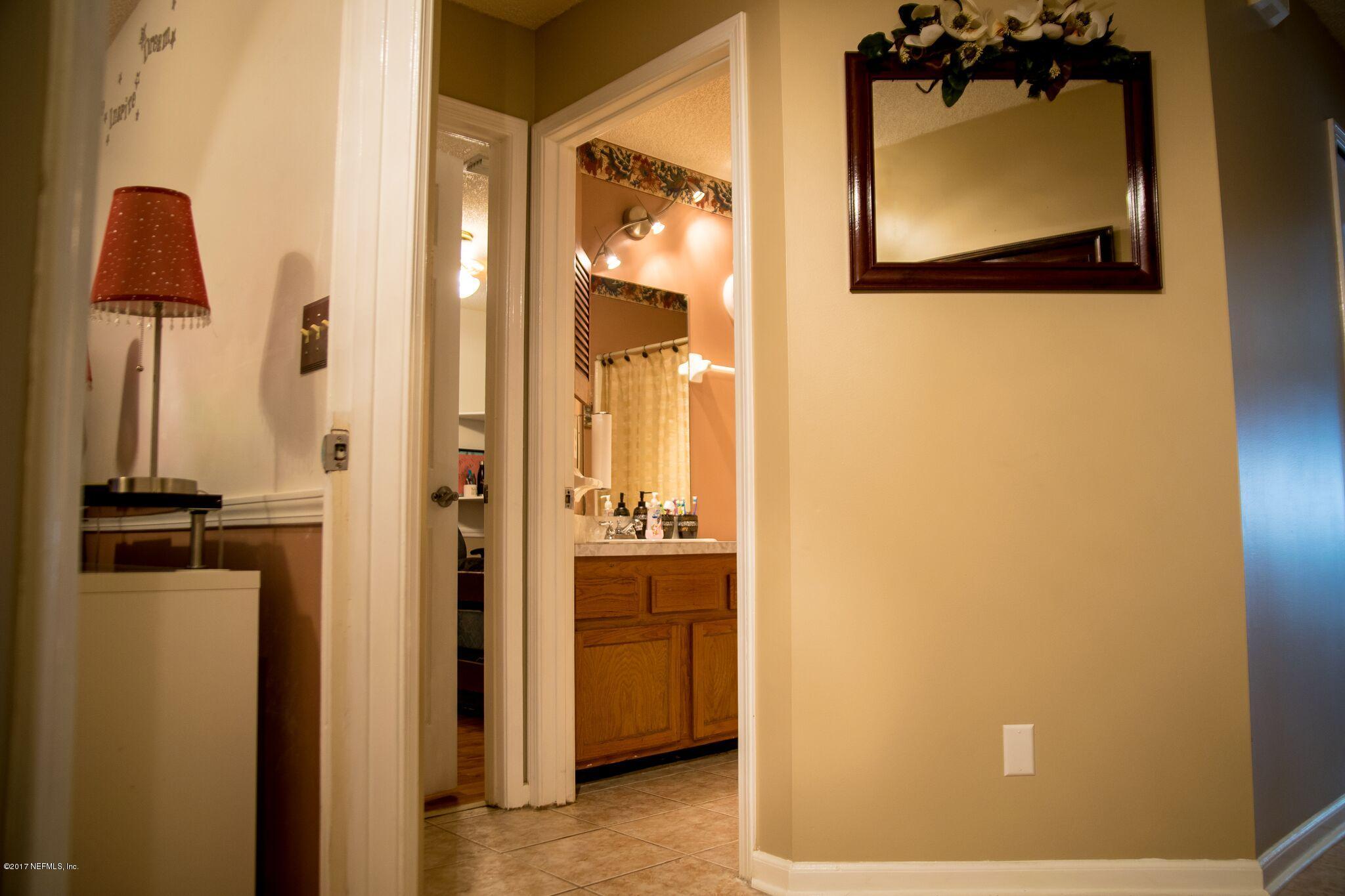 10775 Rutgers Road Jacksonville, FL 32218 - Photo 3 of 10 a view of a bathroom with a sink and mirror