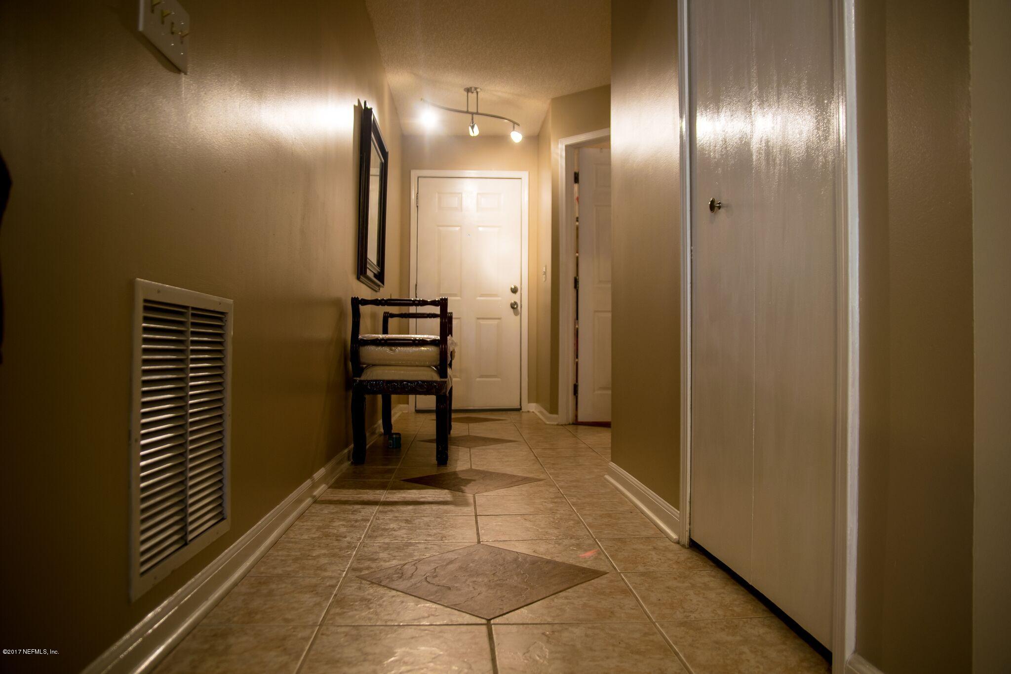 10775 Rutgers Road Jacksonville, FL 32218 - Photo 4 of 10 a view of a hallway with entryway and a livingroom