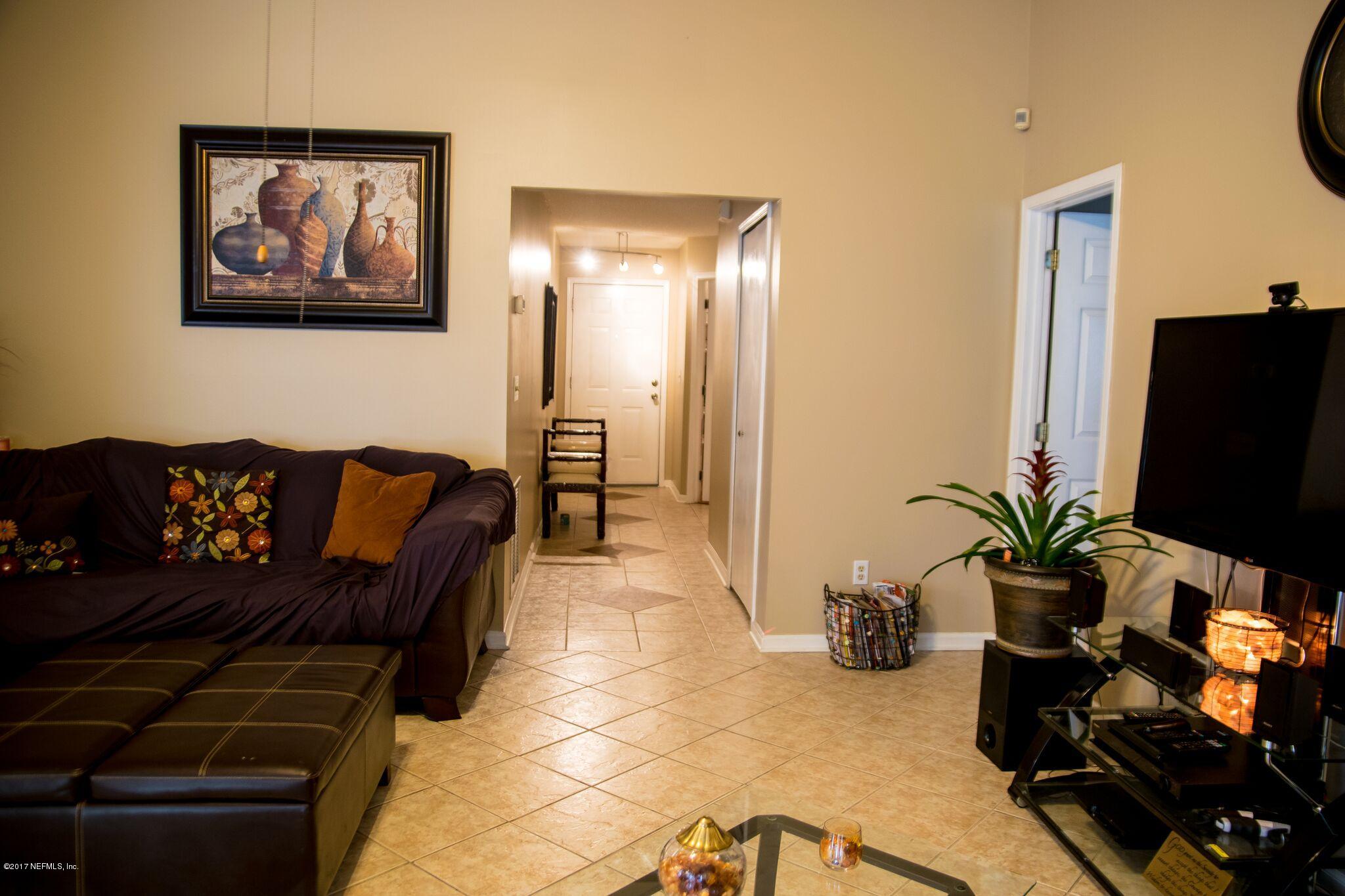 10775 Rutgers Road Jacksonville, FL 32218 - Photo 5 of 10 a living room with furniture and a flat screen tv