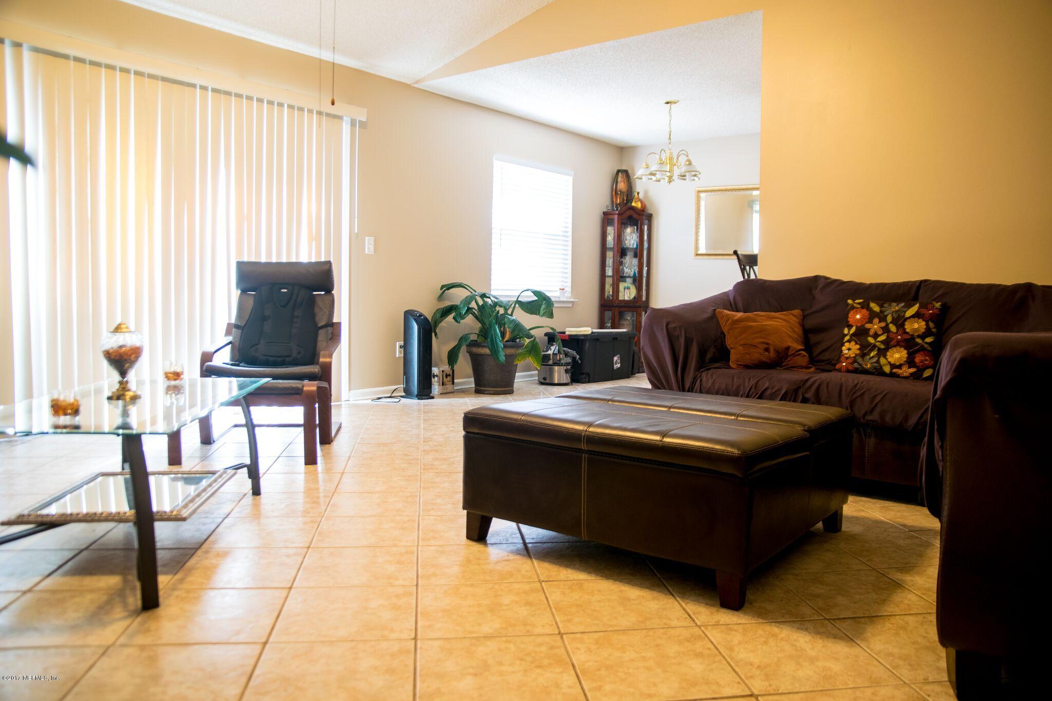 10775 Rutgers Road Jacksonville, FL 32218 - Photo 6 of 10 a living room with furniture and a large window