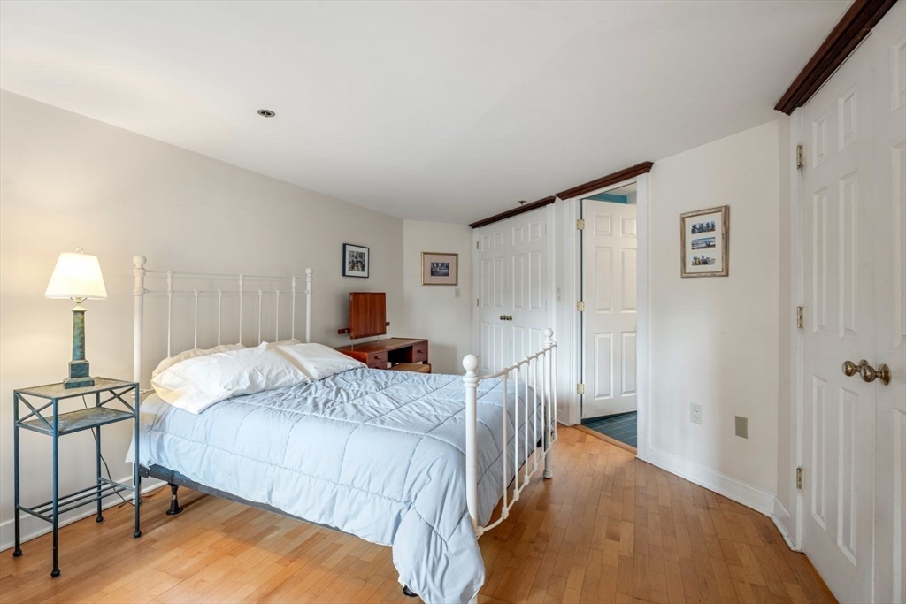 100 Fulton Street, Unit 4V Boston, MA 02109 - Photo 17 of 42 a bedroom with a bed and a lamp