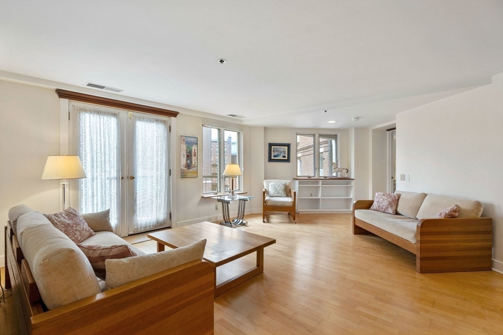 100 Fulton Street, Unit 4V Boston, MA 02109 - Photo 4 of 42 a living room with furniture and a large window