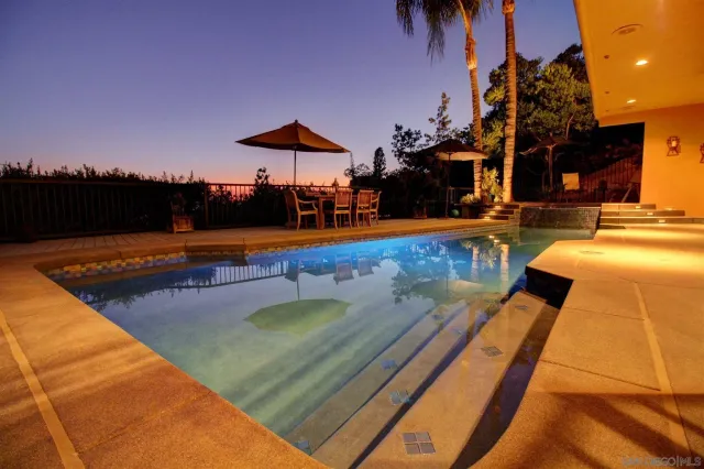 a view of a swimming pool with a table and chairs