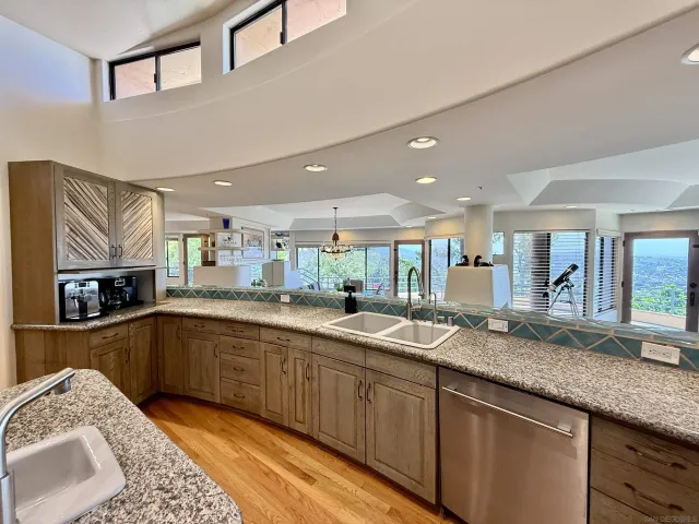 a kitchen with granite countertop a sink and stove