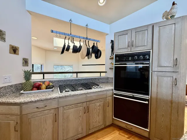 a kitchen with white cabinets and appliances