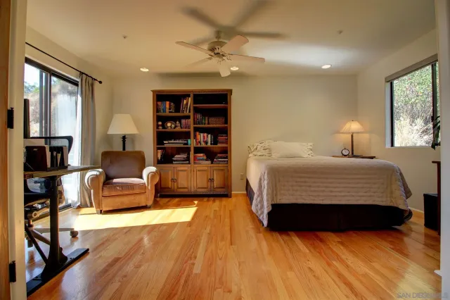 a bedroom with a large bed a couch and a window