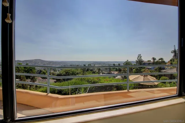 a view of a chairs and table in the balcony