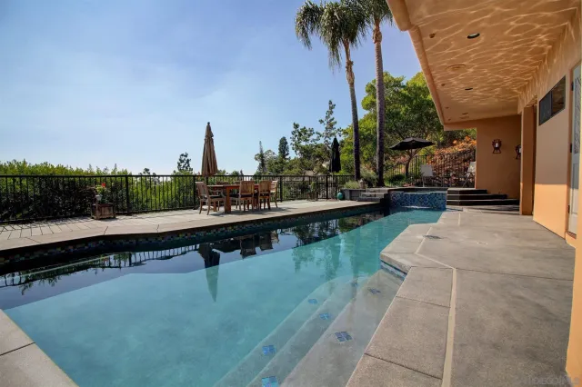 a view of swimming pool with chairs