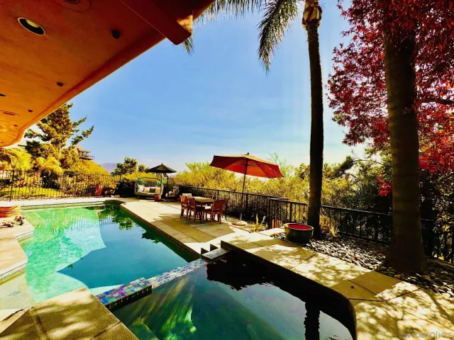 a view of swimming pool with chairs