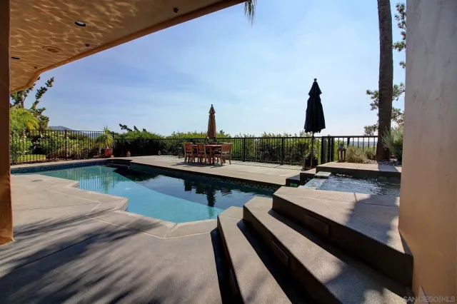 a view of swimming pool with deck and a garden