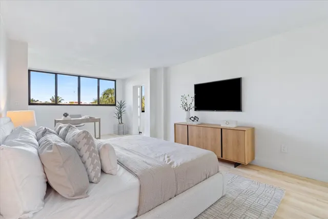 a bedroom with a bed and a flat screen tv