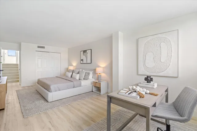 a bedroom with a bed and a table