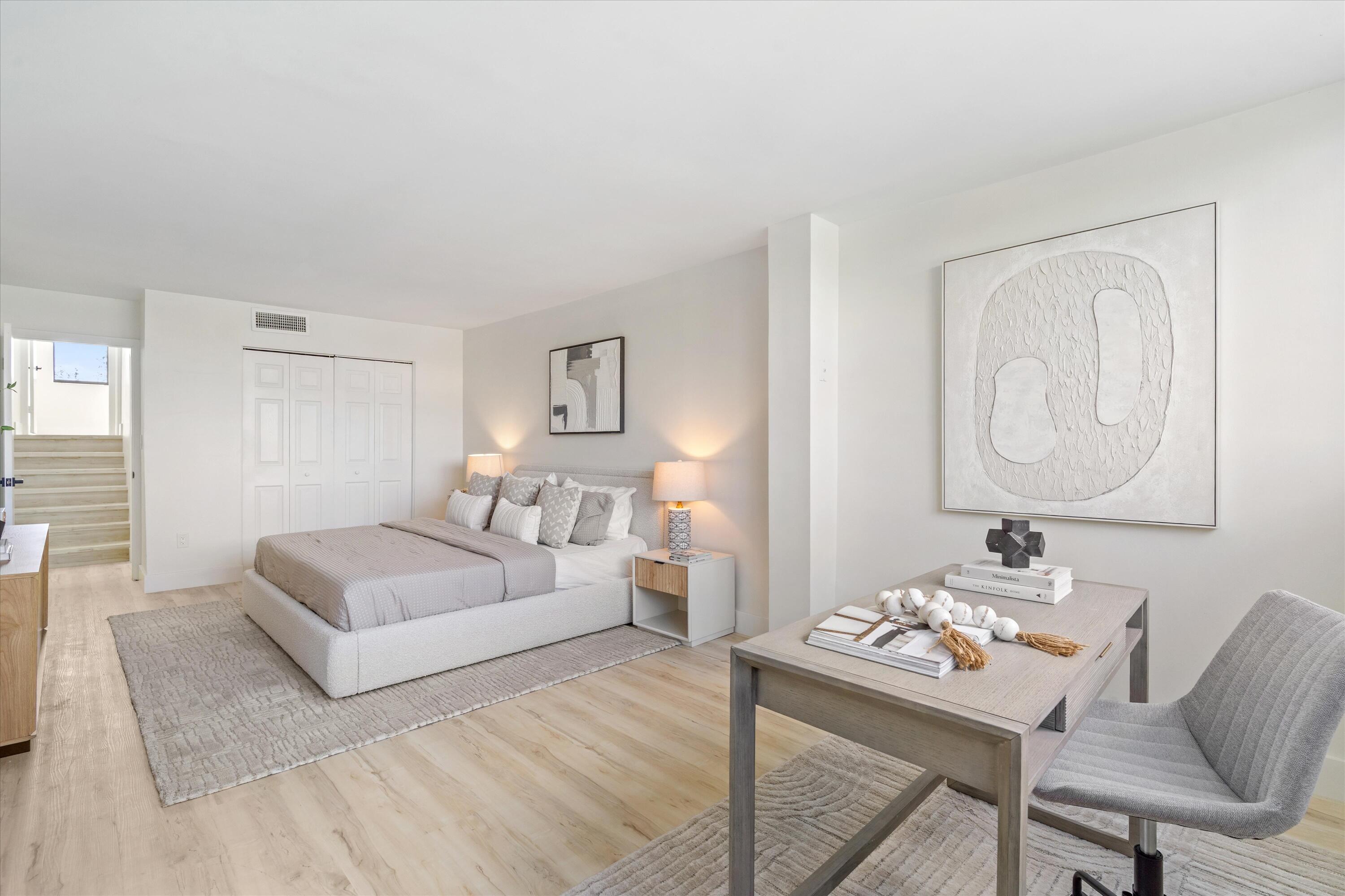 755 Dotterel Road, Unit 1307 Delray Beach, FL 33444 - Photo 16 of 36 a bedroom with a bed and a table