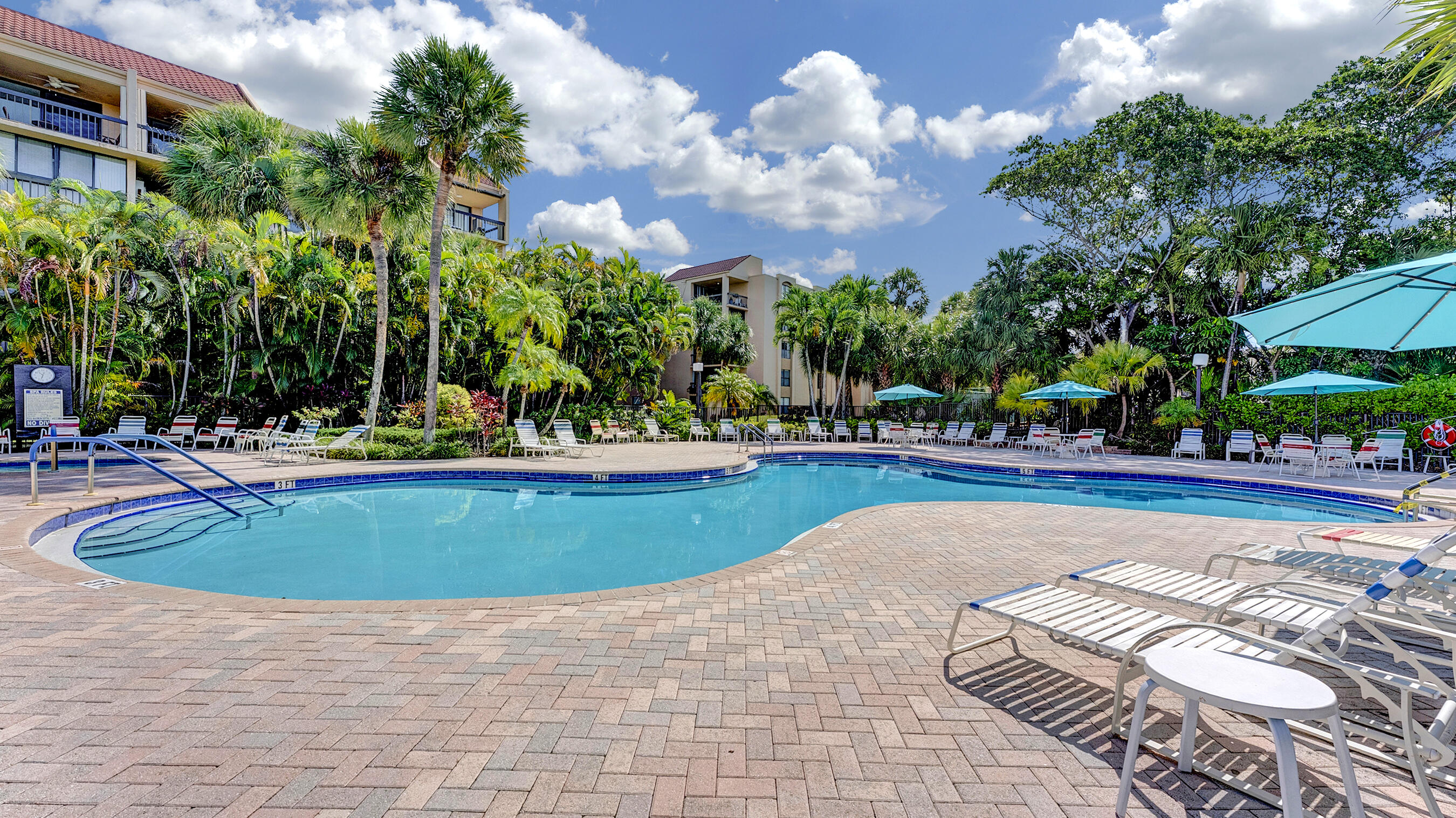755 Dotterel Road, Unit 1307 Delray Beach, FL 33444 - Photo 26 of 36 a view of swimming pool with outdoor seating and trees