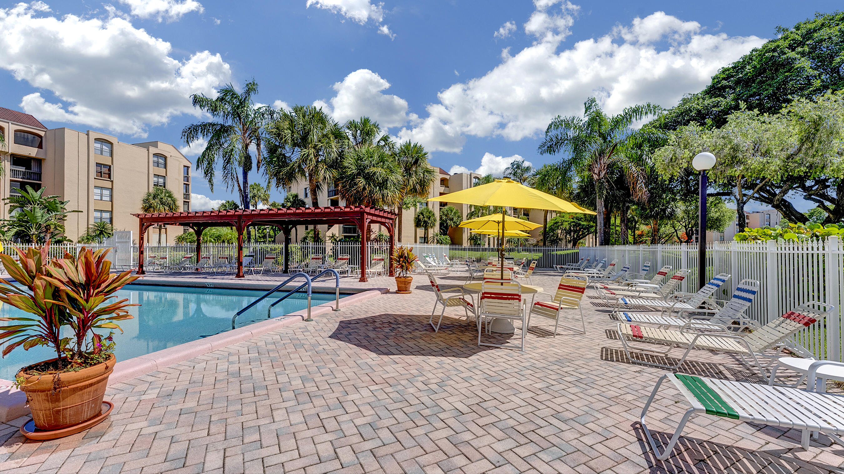 755 Dotterel Road, Unit 1307 Delray Beach, FL 33444 - Photo 29 of 36 a view of a swimming pool with a patio and a garden