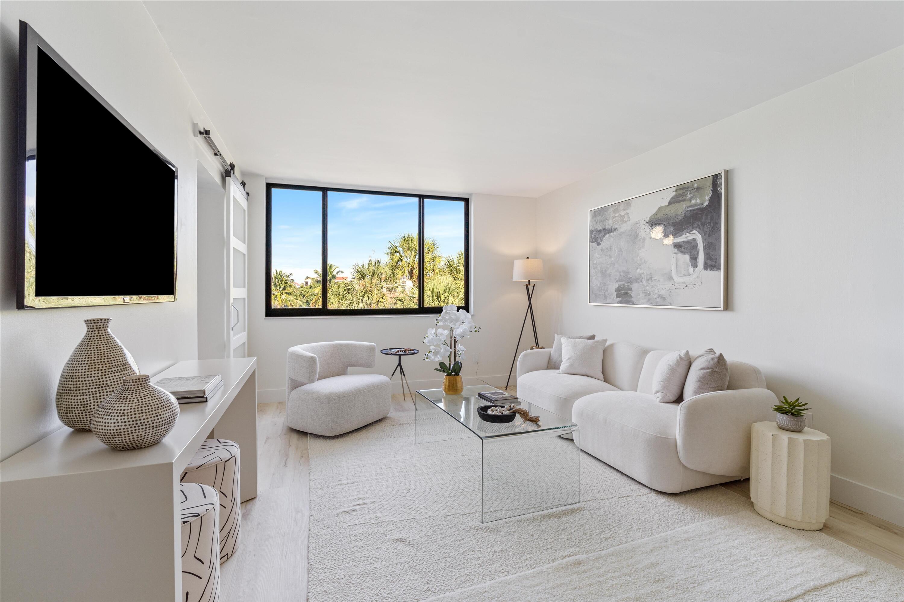 755 Dotterel Road, Unit 1307 Delray Beach, FL 33444 - Photo 3 of 36 a living room with furniture and a flat screen tv