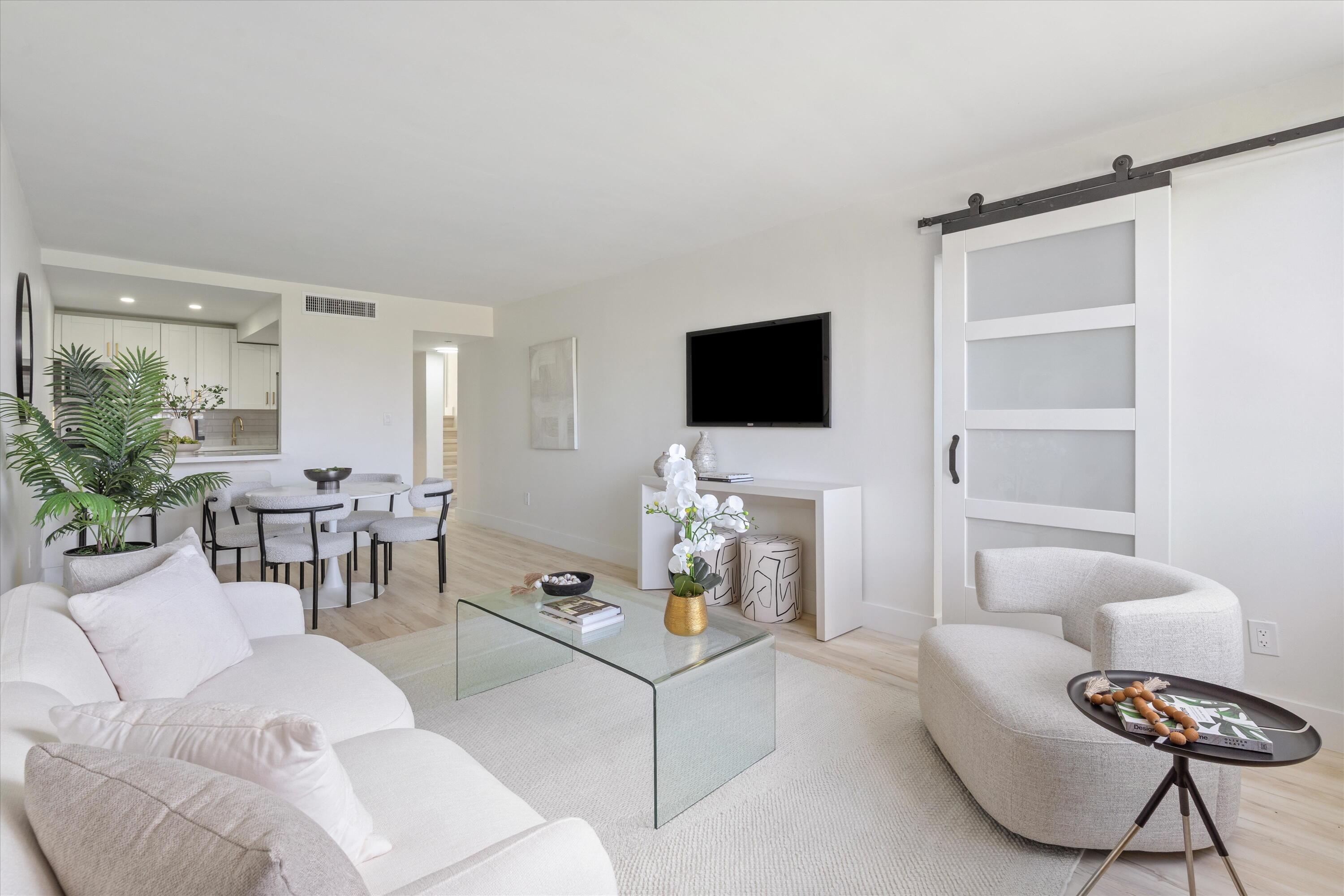 755 Dotterel Road, Unit 1307 Delray Beach, FL 33444 - Photo 5 of 36 a living room with furniture and a flat screen tv