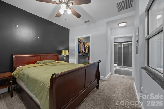 a bedroom with a large bed and a chandelier