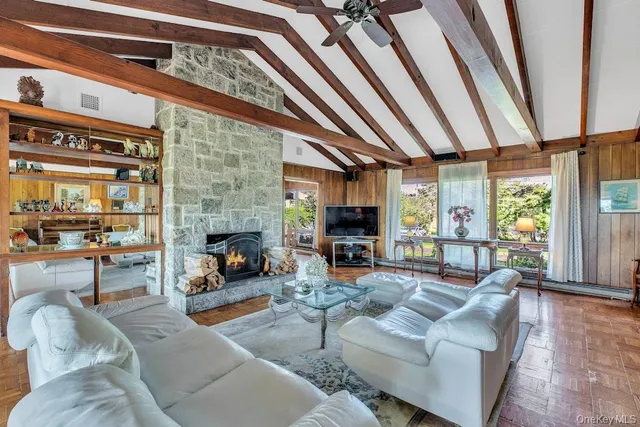 a living room with furniture and a floor to ceiling window