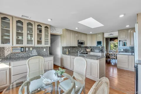 a kitchen with white cabinets and a stove