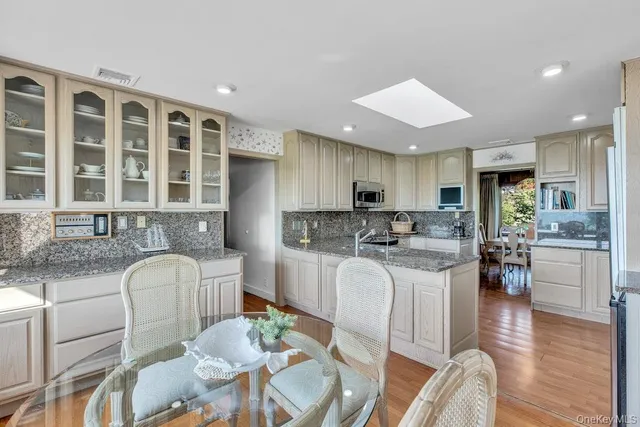 a kitchen with white cabinets and a stove