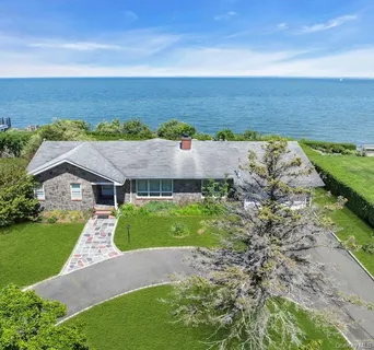 an aerial view of a house with beach and ocean view
