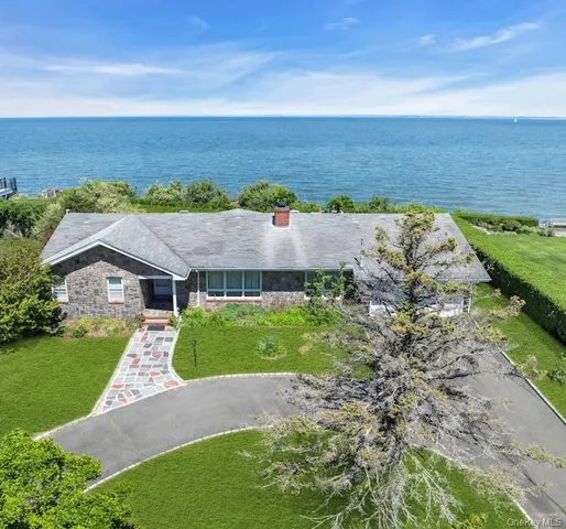 an aerial view of a house with beach and ocean view