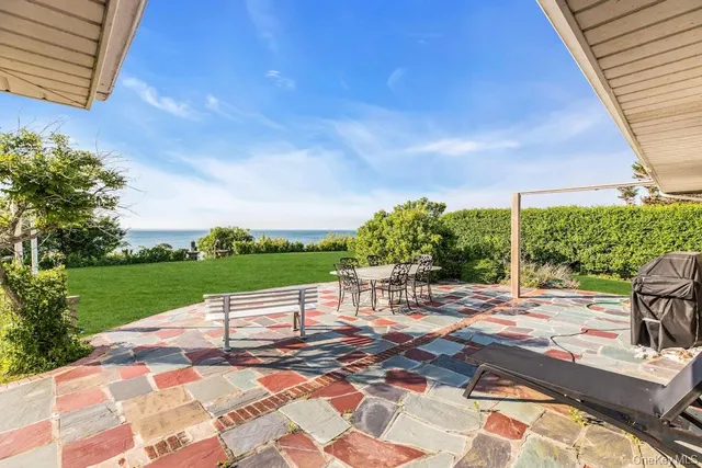 a view of a house with backyard sitting area and garden