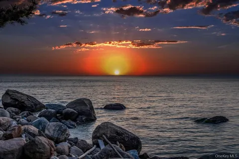 an aerial view of a house with garden space and street view