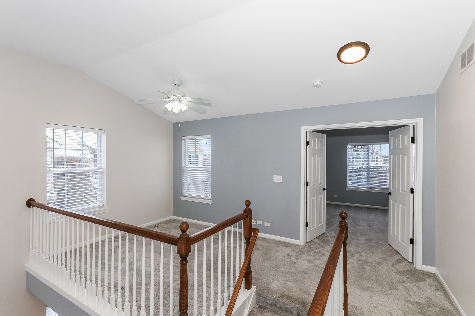 7 Shade Tree Court Algonquin, IL 60102 - Photo 2 of 2 a view of a hallway to a bedroom with windows