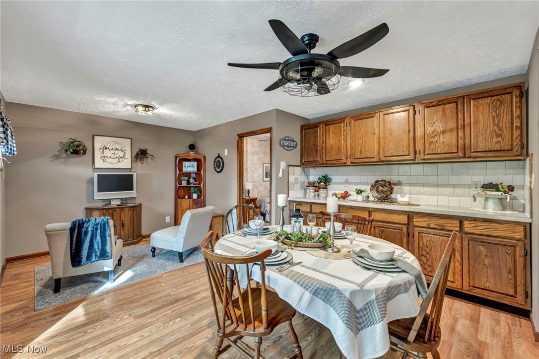 6030 Dunham Road Maple Heights, OH 44137 - Photo 24 of 50 Dining area with light wood-type flooring, a textured ceiling, and ceiling fan