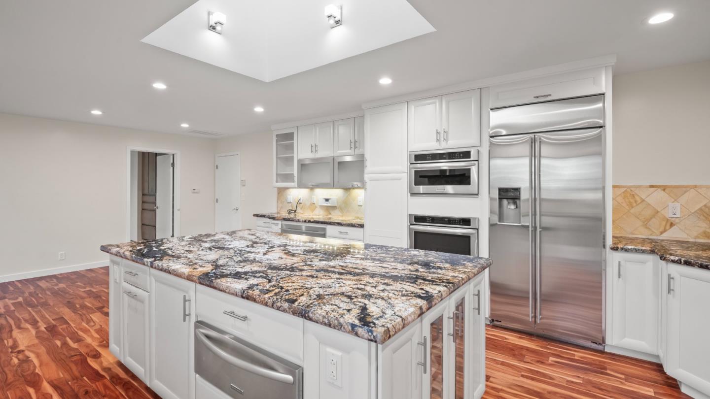 16353 Aztec Ridge Drive Los Gatos, CA 95030 - Photo 36 of 61 a kitchen with kitchen island granite countertop a sink stove and refrigerator