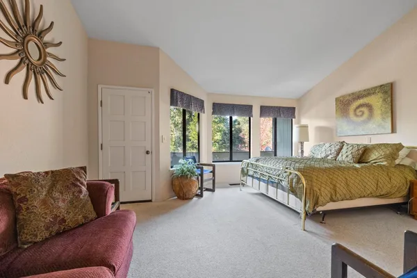 a bed sitting in a bedroom next to a window