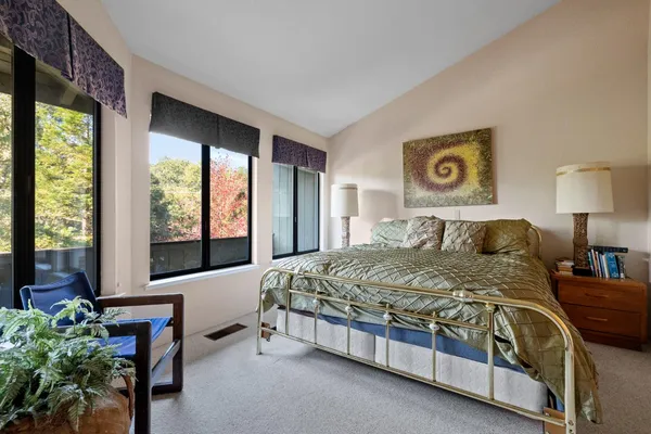 a spacious bedroom with a bed and a couch