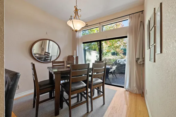 a view of a dining room with furniture and wooden floor