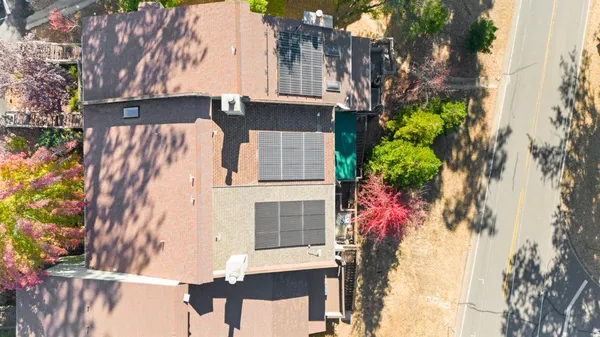 an aerial view of a house with a swimming pool and outdoor space